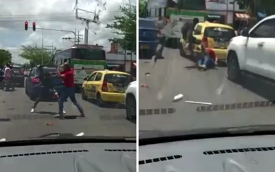 Pelea callejera en Barrancabermeja: Taxista y limpiavidrios se enfrentan a golpes.